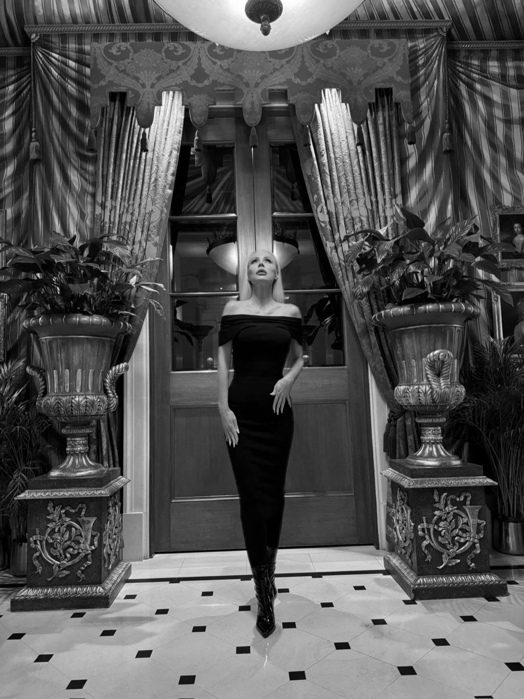 In a grand London doorway, dressed for an evening