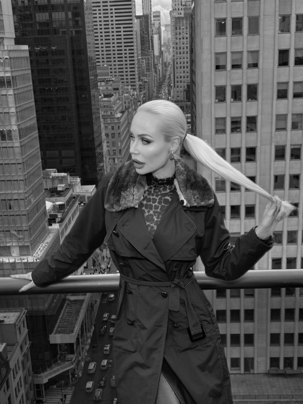A trench coat on a high balcony above the avenue